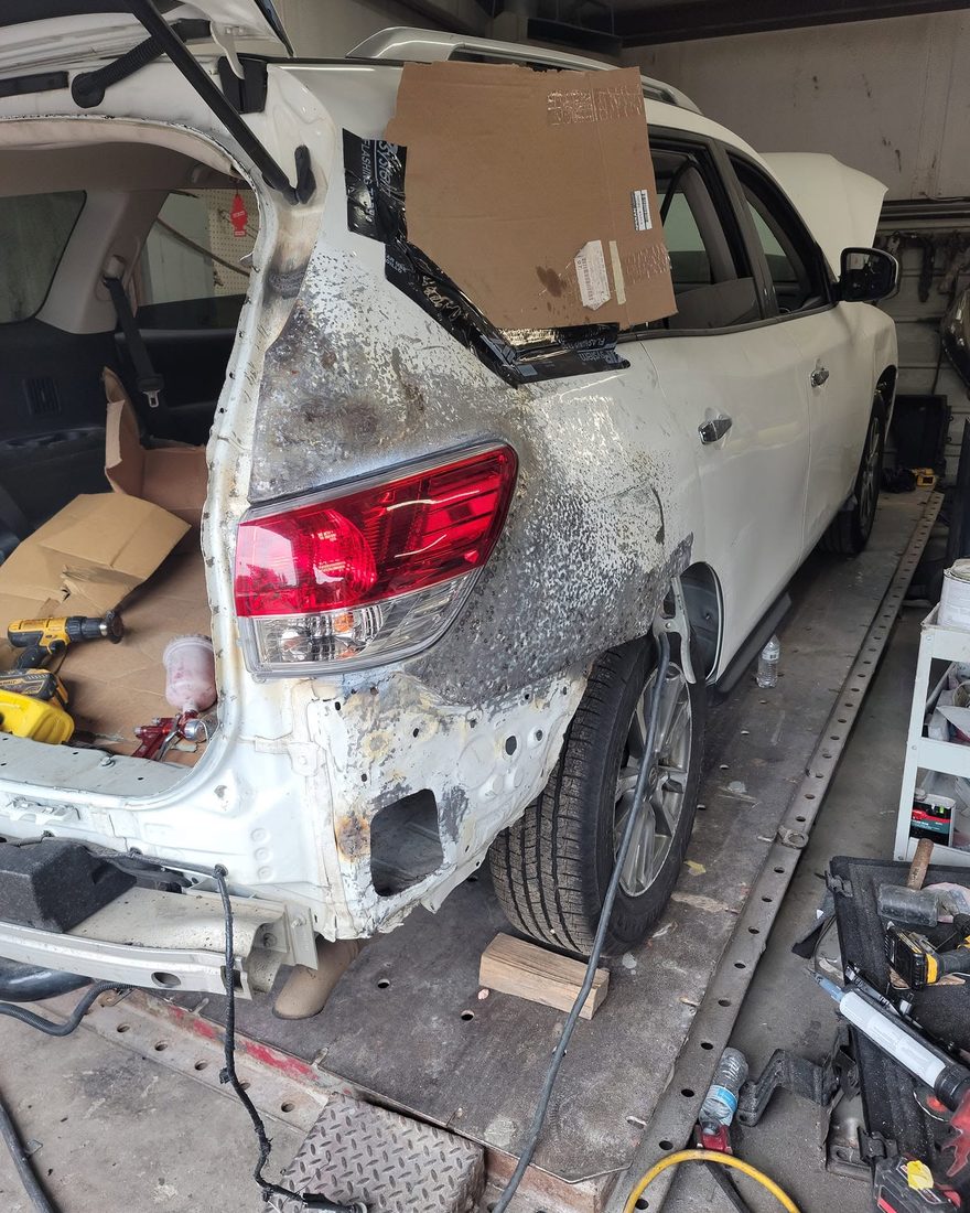 Rear quarter straightened back to bare metal on the frame rack